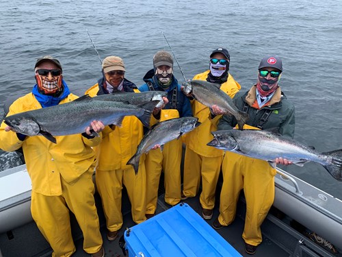 Guests of Waterfall resort, a top Alaska fishing lodge, displaying their Alaska king salmon catches.